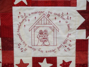 1h christmas carols quilt close up